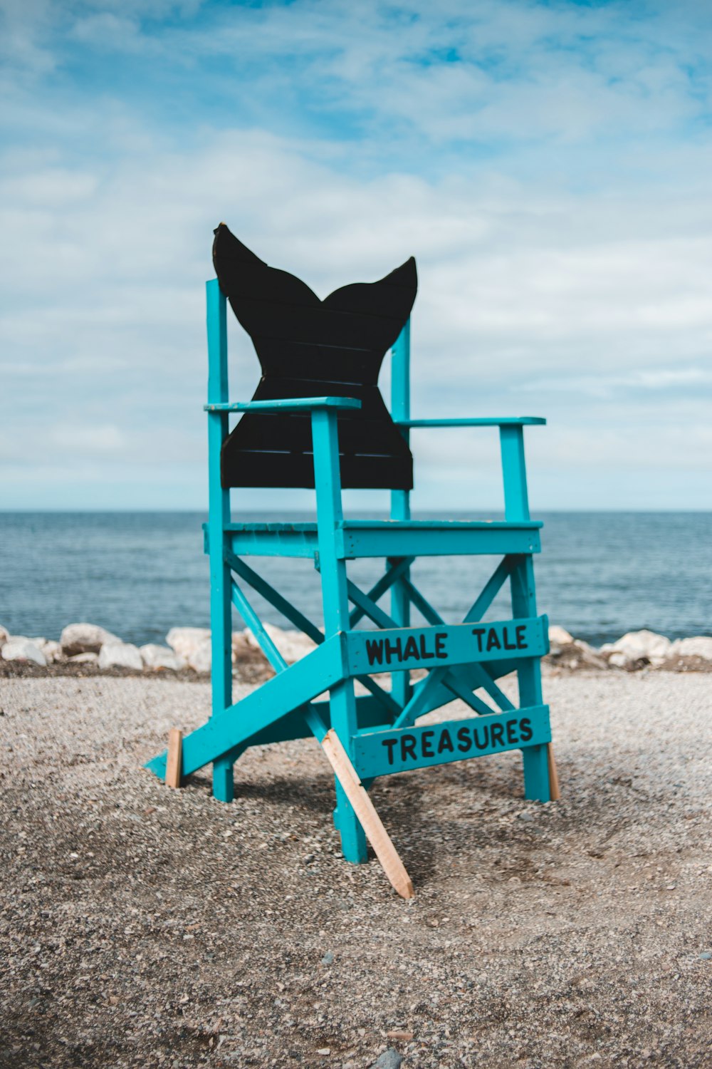 blue wooden lifeguard chair on beach shore during daytime