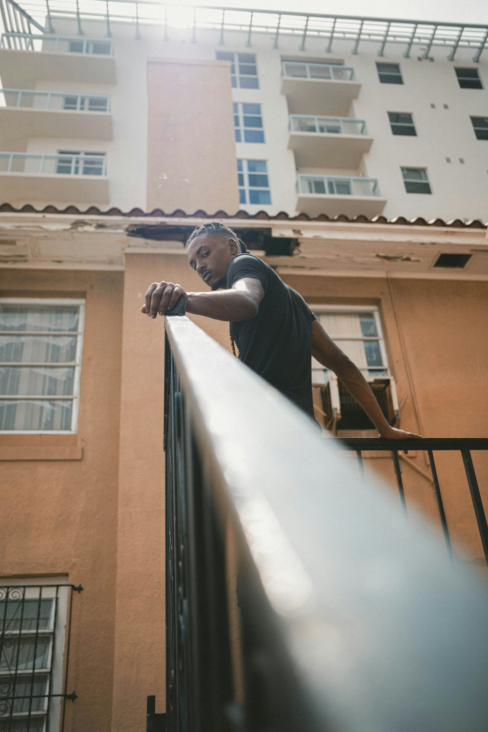 man in black long sleeve shirt standing on stairs