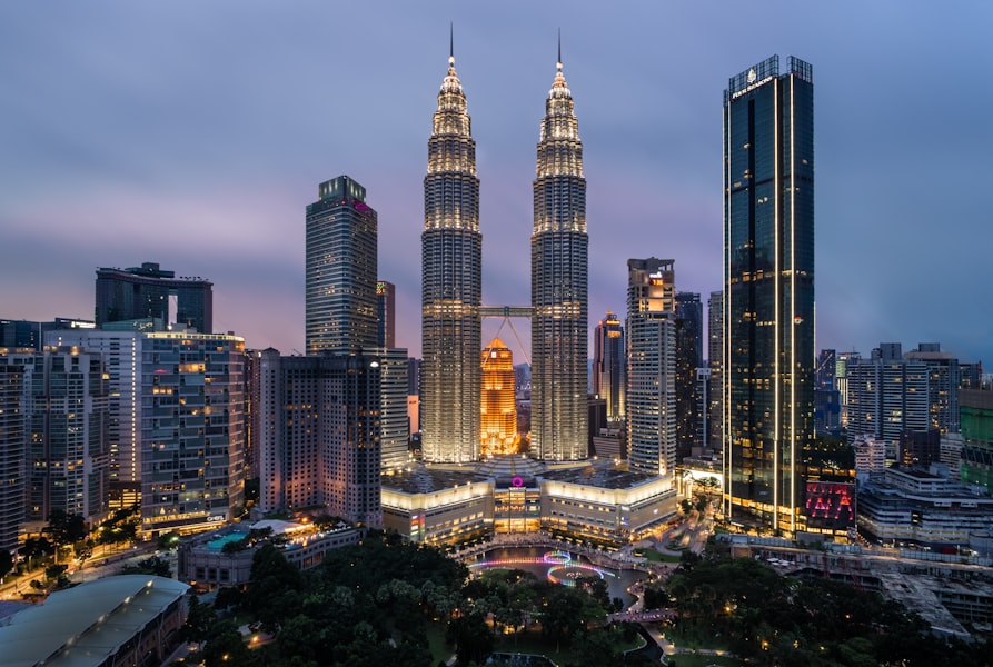 Kuala Lumpur skyline at night with the Petronas Twin Towers illuminated against the city lights