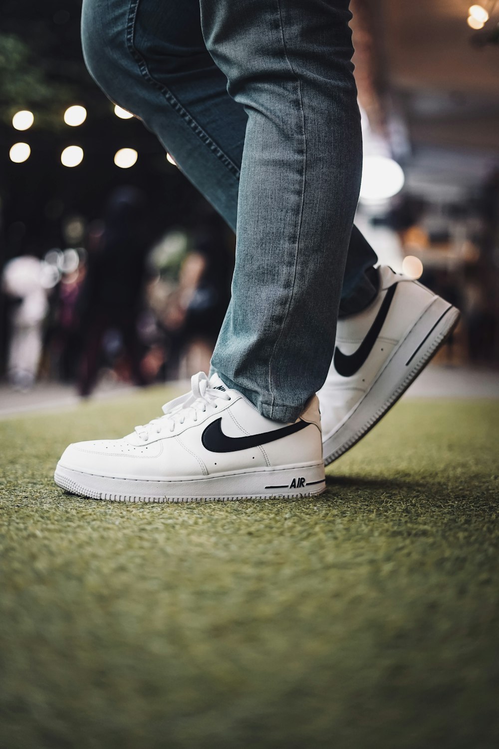 person in blue denim jeans wearing white nike sneakers photo – Free Image  on Unsplash
