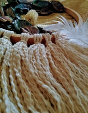 Close-up of a beautifully crocheted handmade craft with natural earthy tones and subtle gold accents.