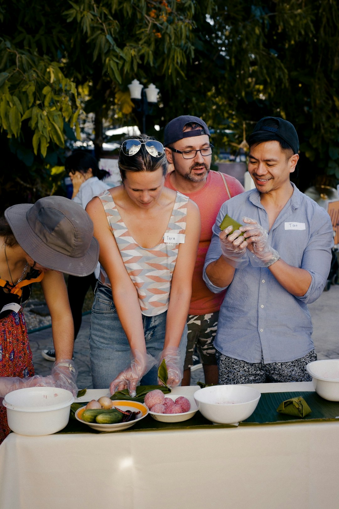 man in gray polo shirt holding woman in white tank top