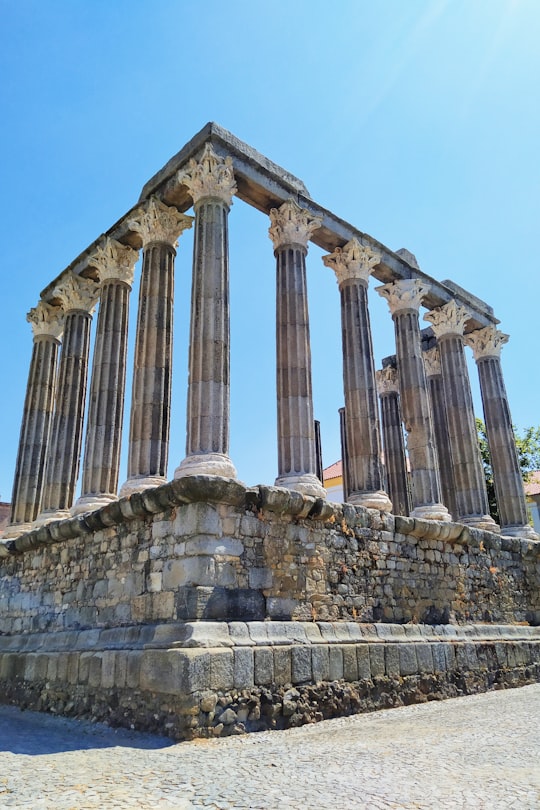 brown concrete building under blue sky during daytime in Roman Temple of Évora Portugal