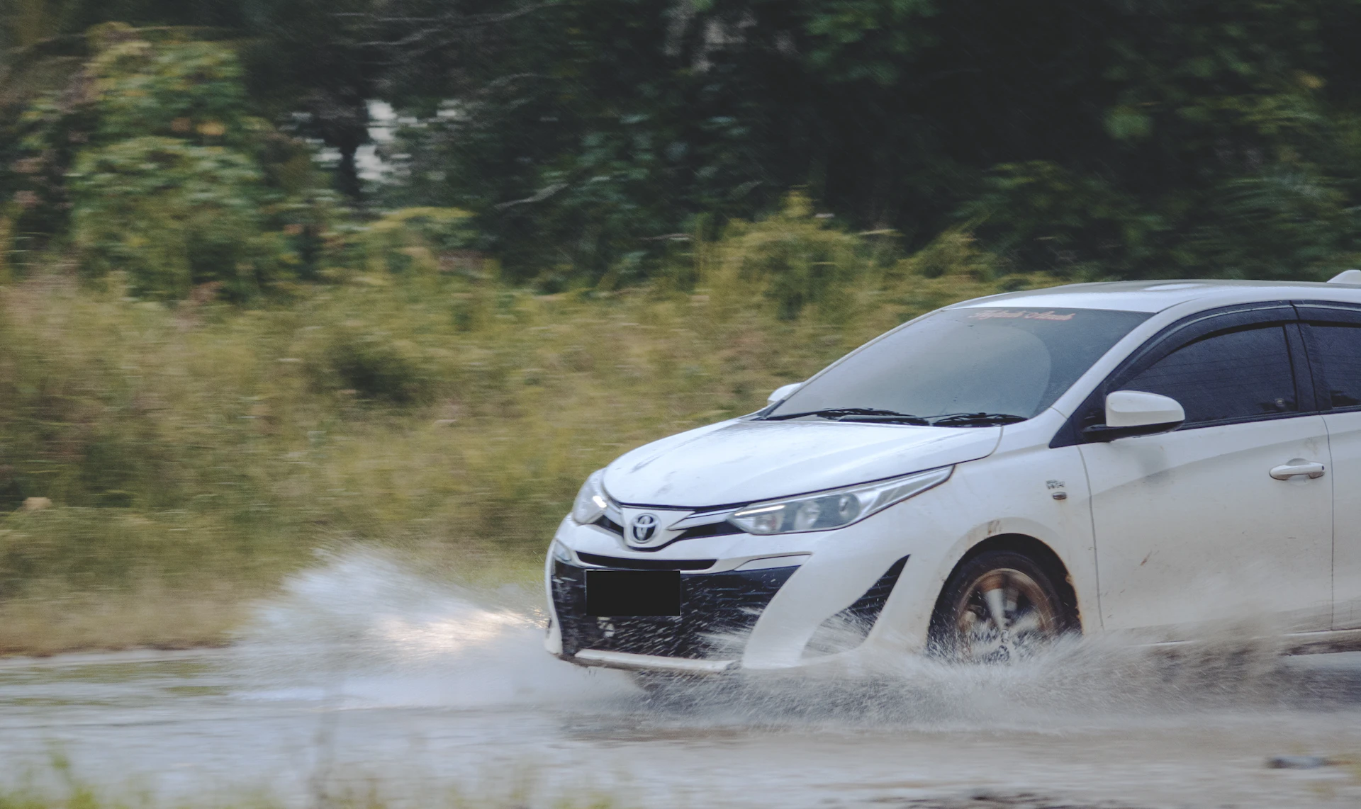 White Toyota Yaris on a country road