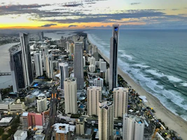 Aerial view of a luxury Florida high-rise skyline at sunset, highlighting sleek condo towers.