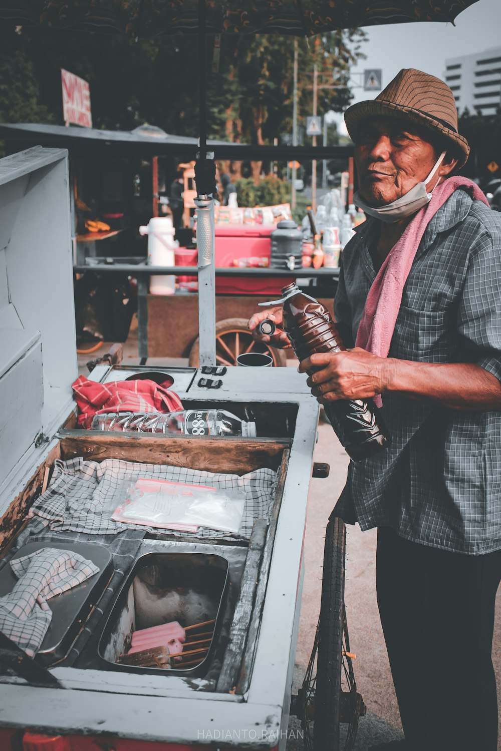 man in black and white checkered button up shirt standing beside gray stove