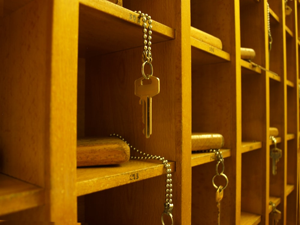 silver chain link necklace on brown wooden shelf