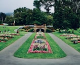A serene park area with neatly arranged flower beds.