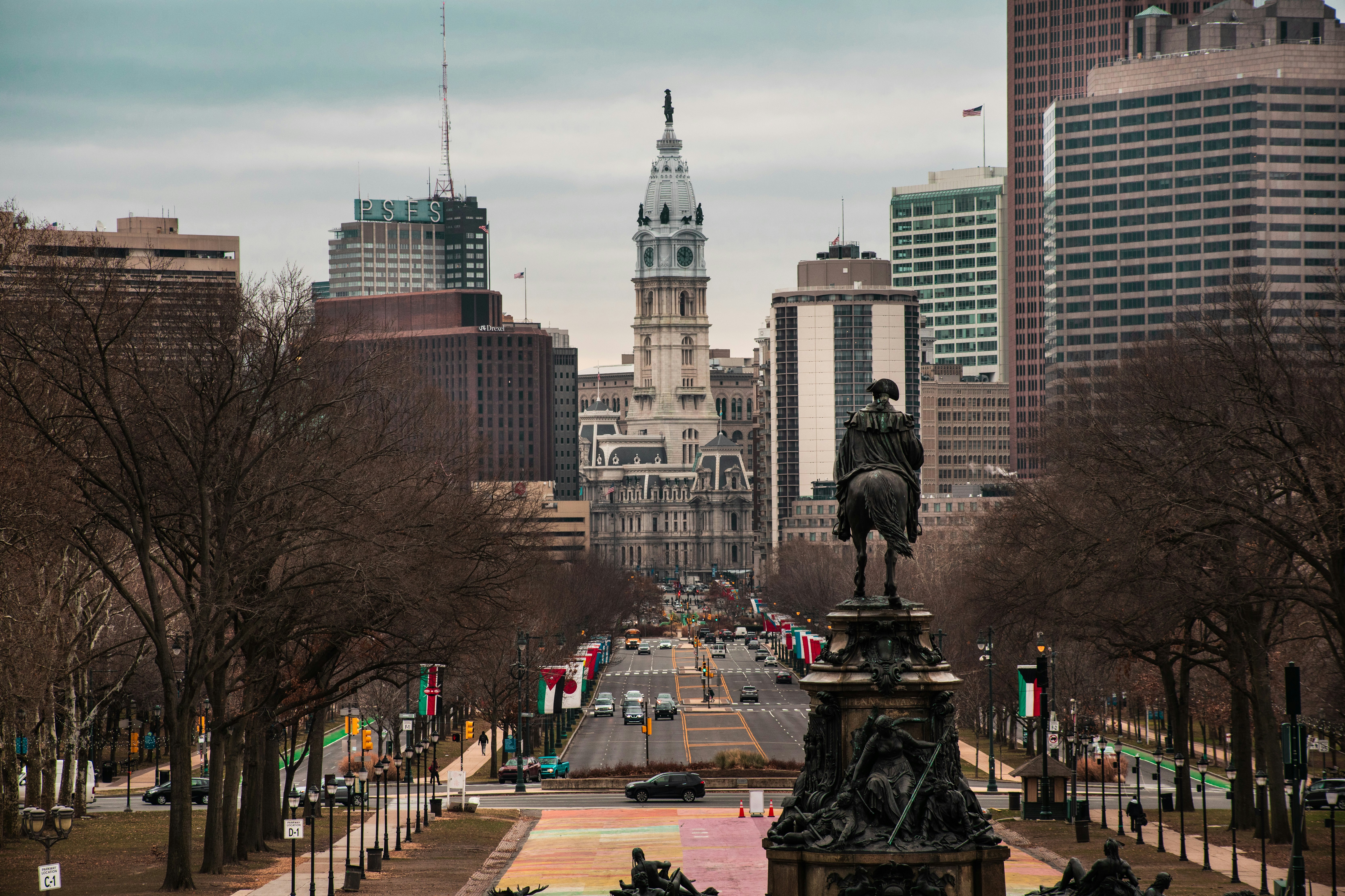 black statue in the middle of the city during daytime