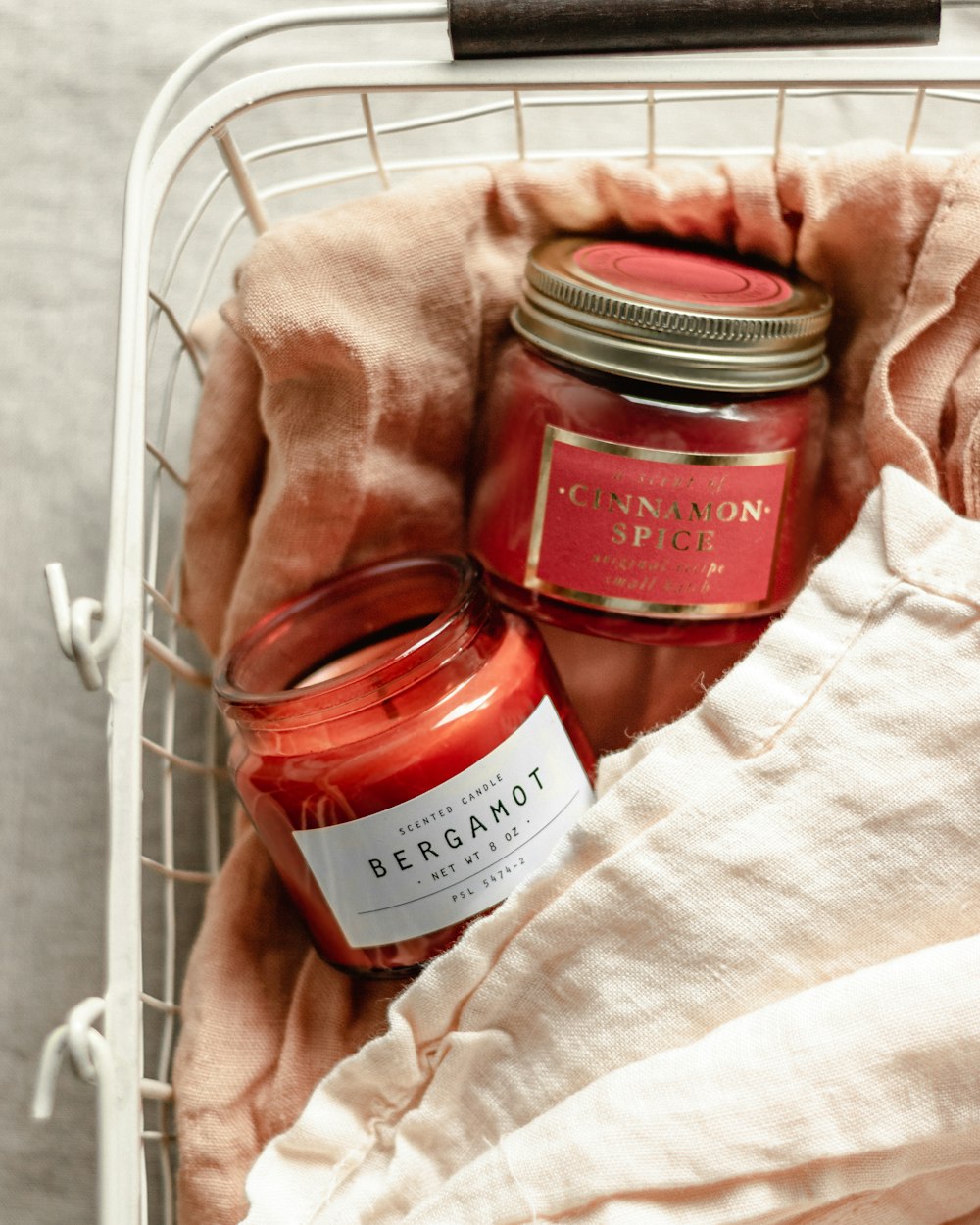 clear glass jar on white textile