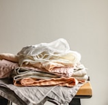 white textile on brown wooden table