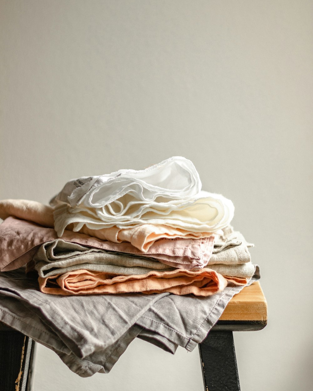 white textile on brown wooden table