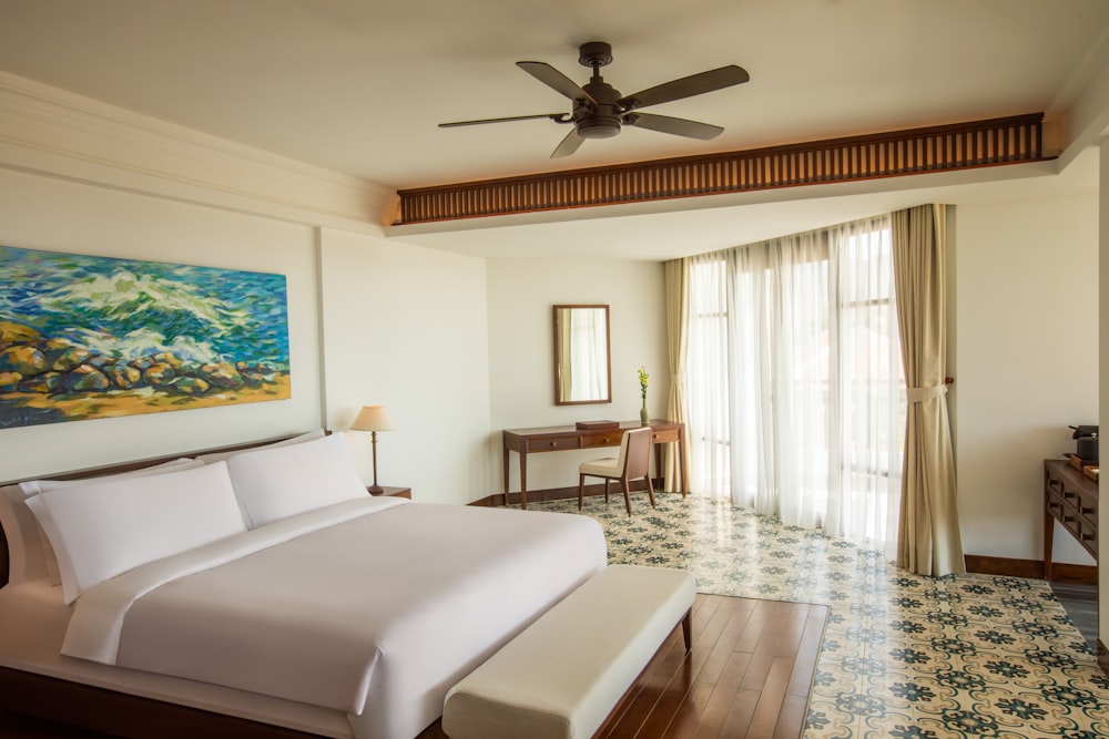 white bed near brown wooden chair