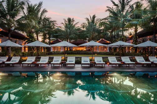 A sunlit poolside lounge with cozy chairs and vibrant greenery at Ever Shine Resort.