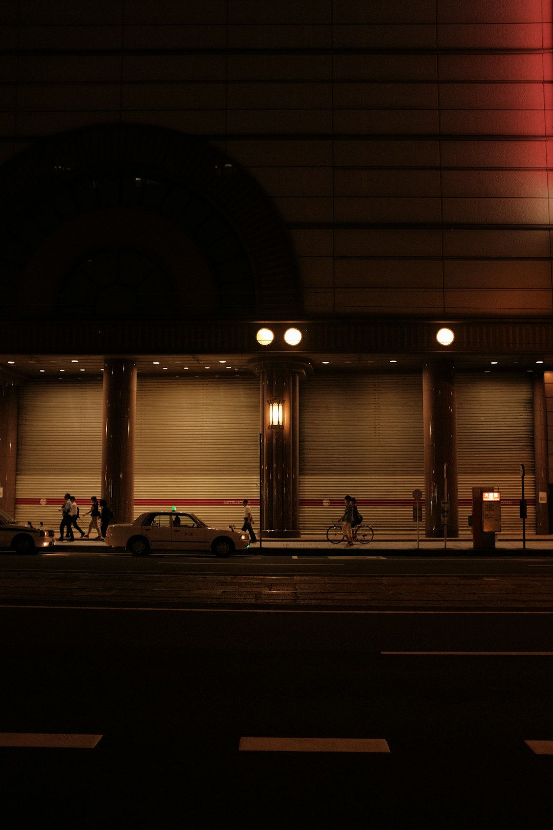 people sitting on bench in front of window