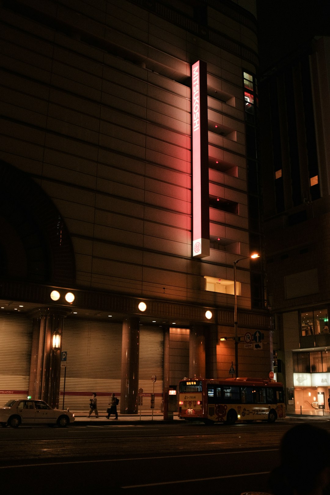 people walking on sidewalk during nighttime