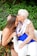 man in brown suit kissing woman in blue dress