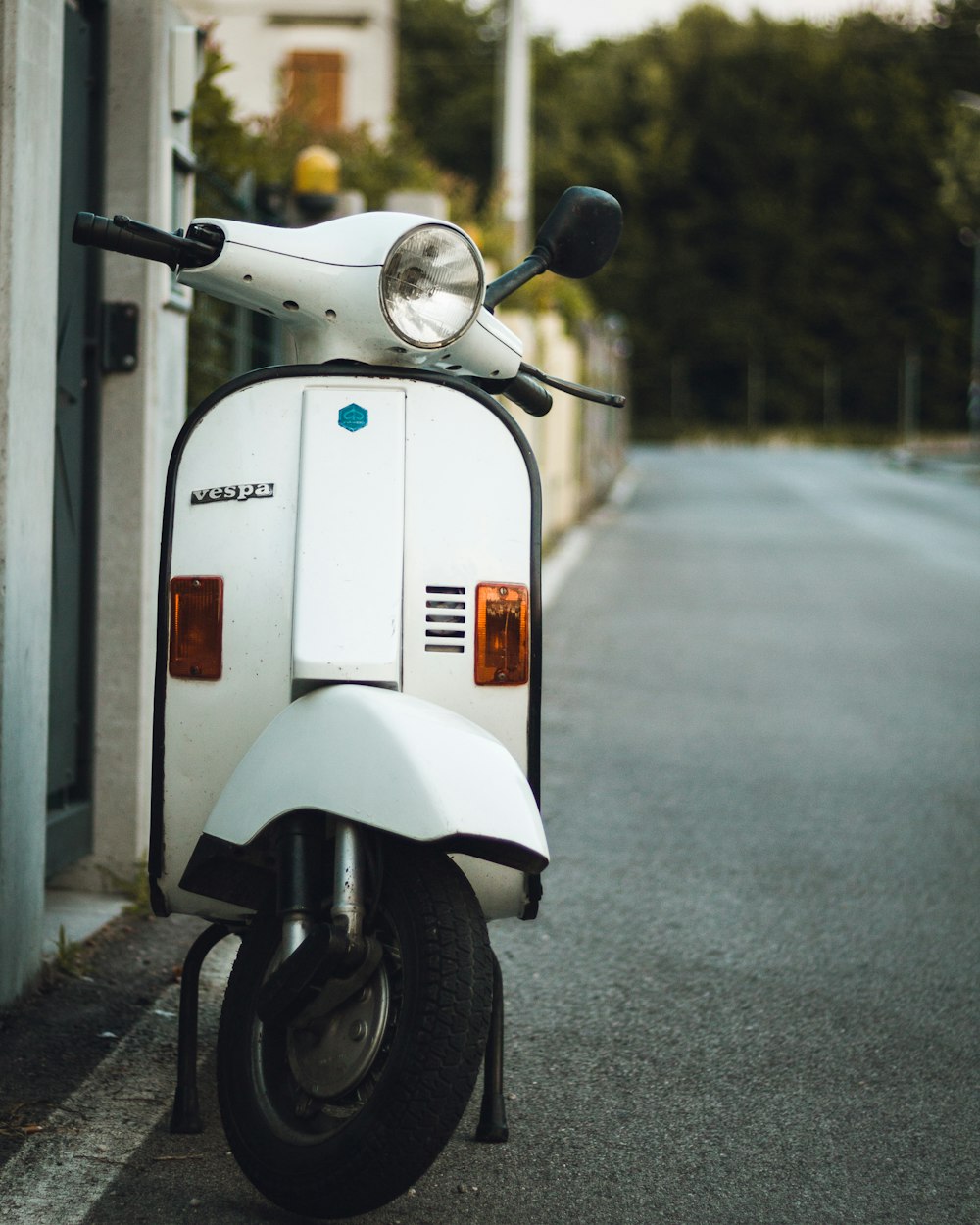 white and black motor scooter on road during daytime