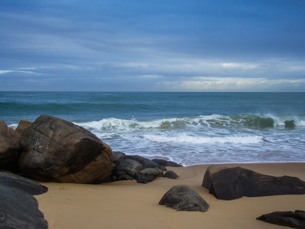 brown rock formation on seashore during daytime