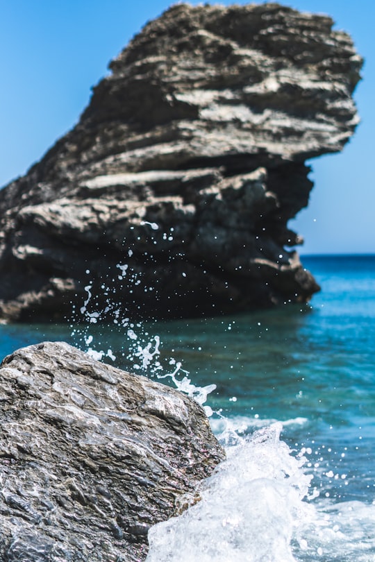 brown rock formation near body of water during daytime in Amorgos Greece