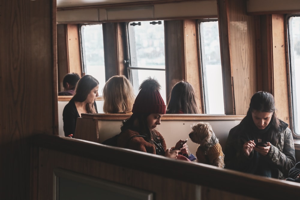 people sitting on chair near window