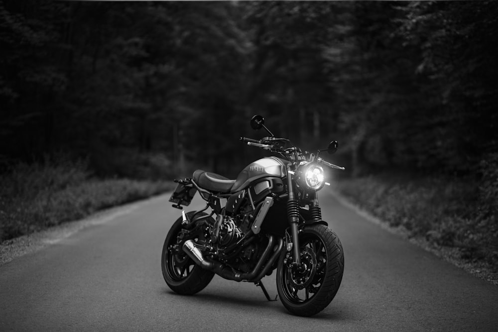 grayscale photo of motorcycle on road