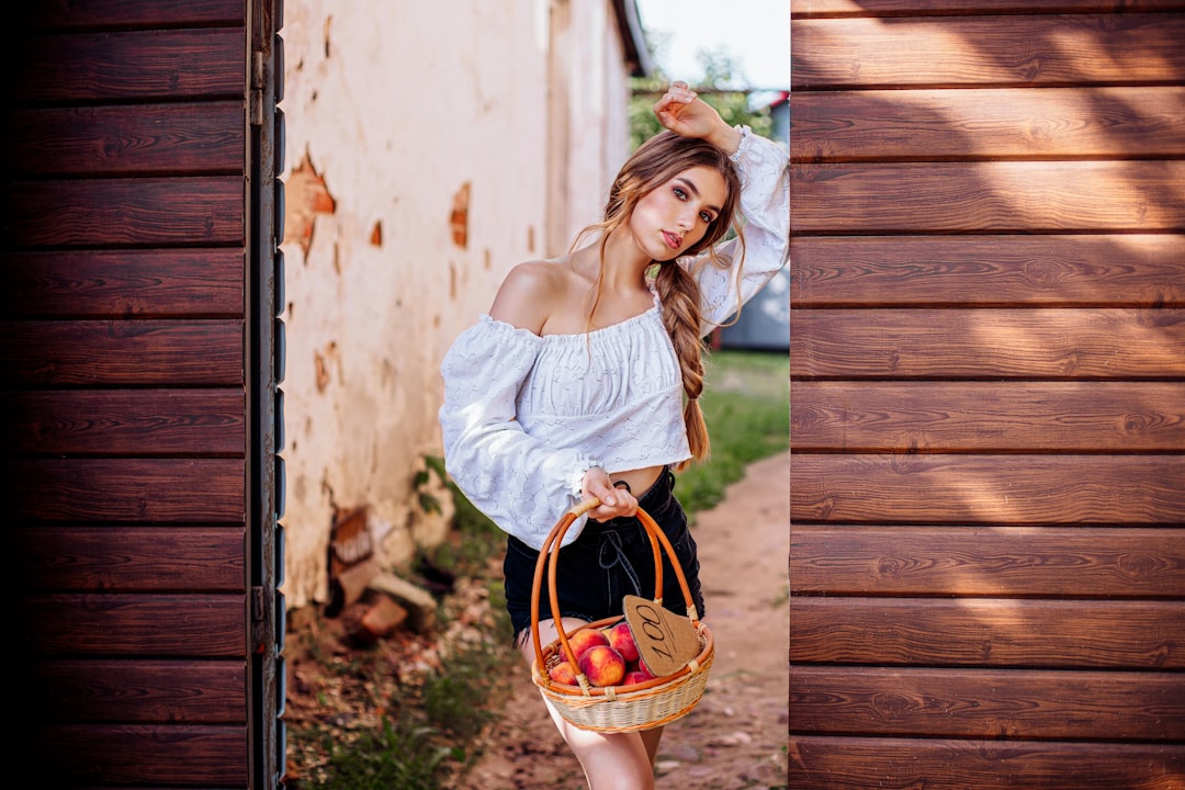 girl in white dress holding brown woven basket
