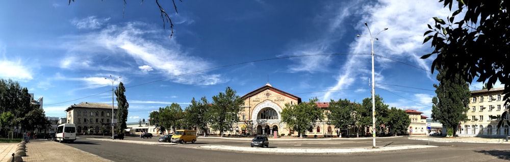 red and white concrete building near green trees under blue sky during daytime