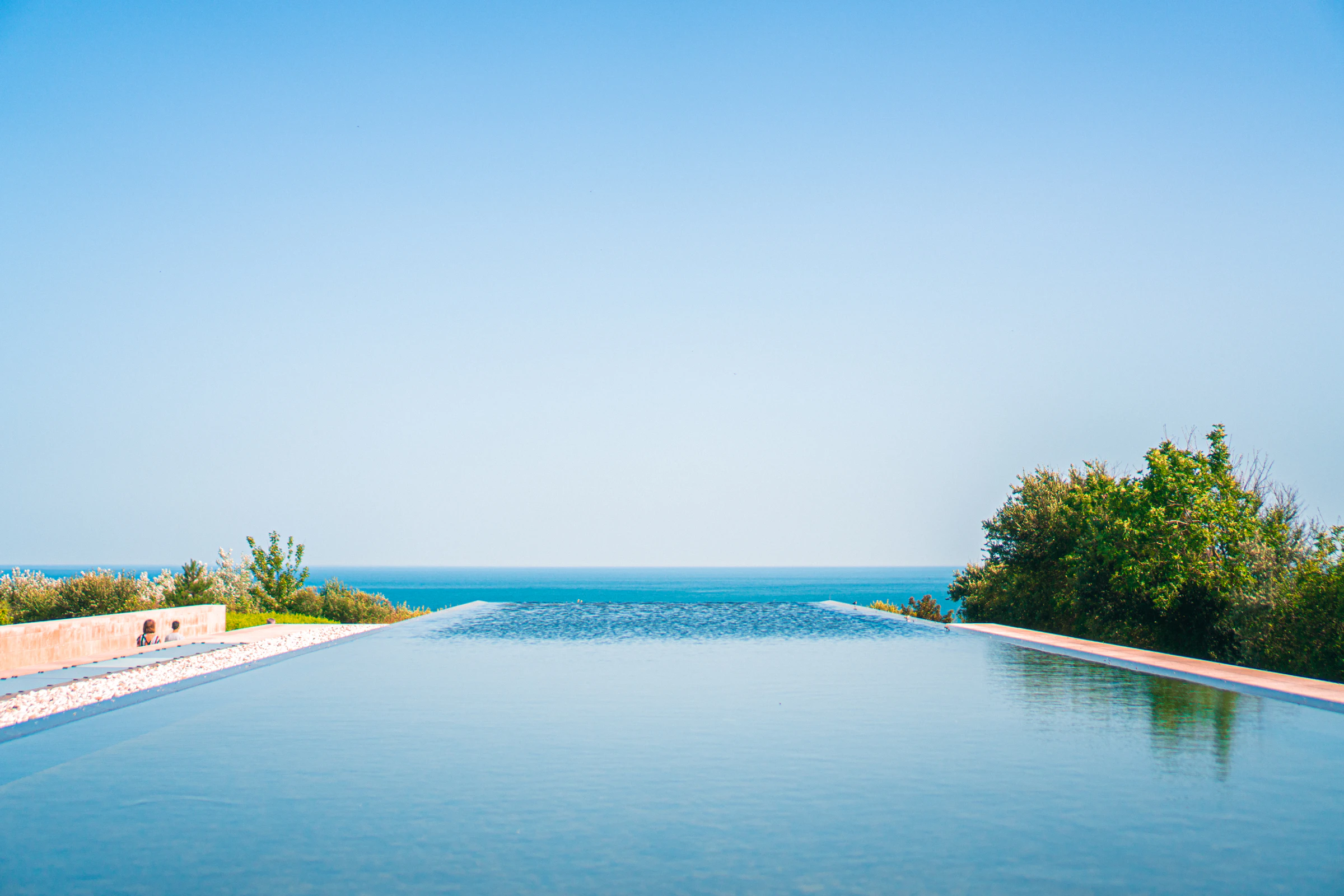 Infinity pool meeting the sea horizon