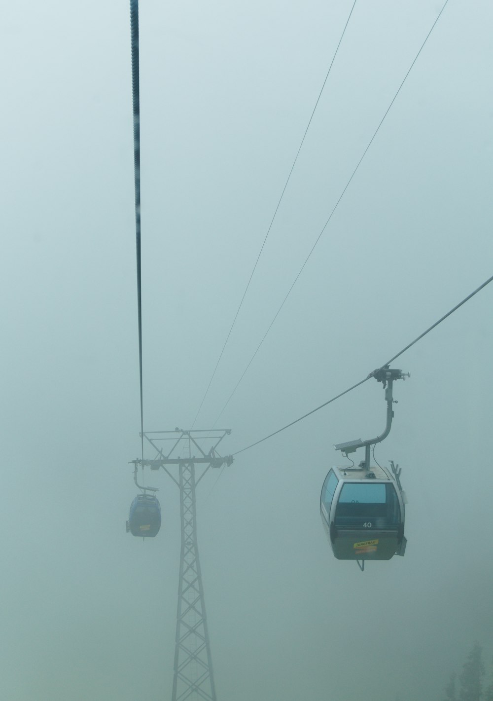 white cable car under gray sky