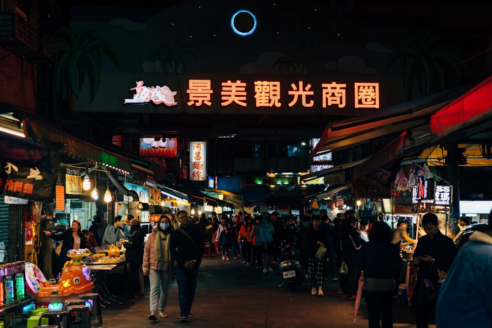 people walking on street during nighttime