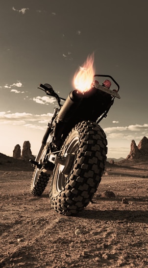A stunning Ducati Desert X parked against the backdrop of the Sahara Desert.