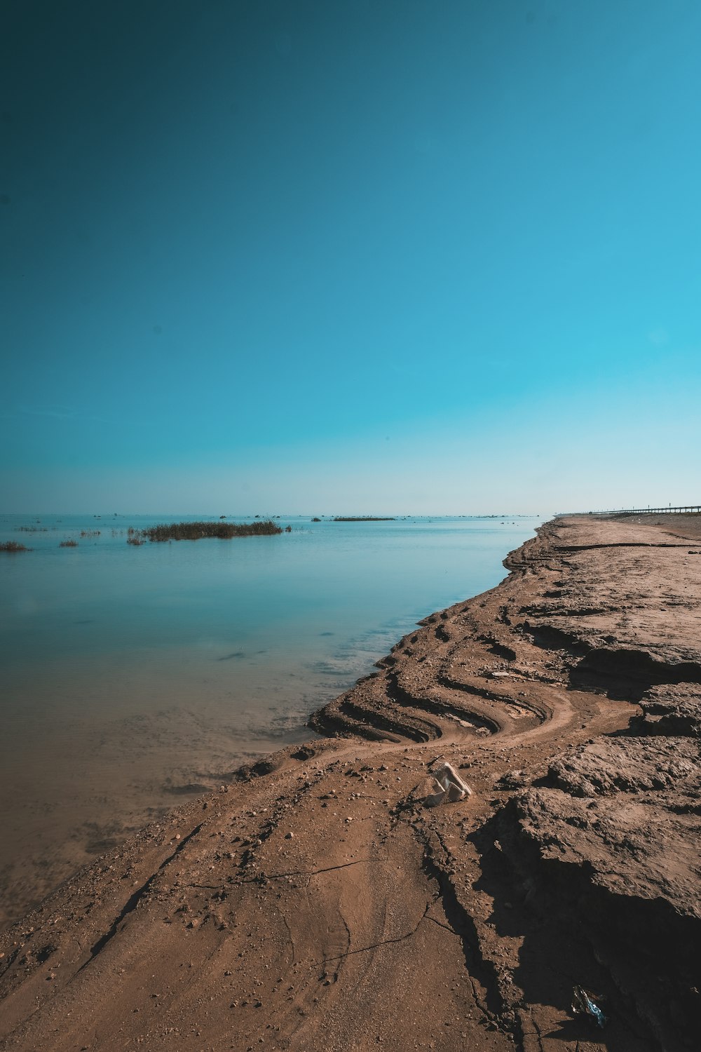 brown rock formation near body of water during daytime