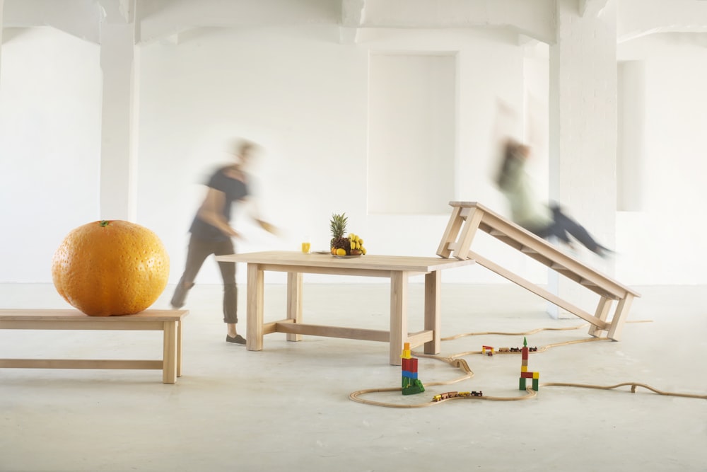 white wooden table with orange pumpkin on top