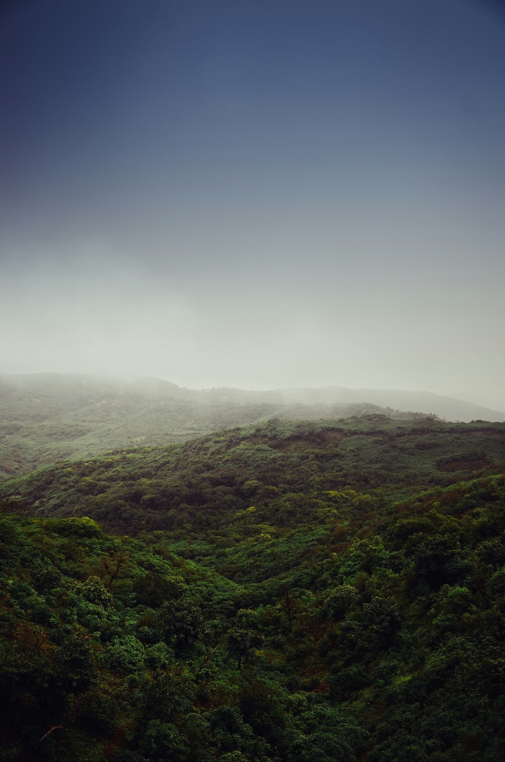 green mountains under white clouds during daytime