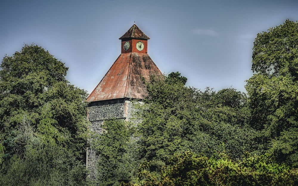 brown concrete building near green trees under blue sky during daytime