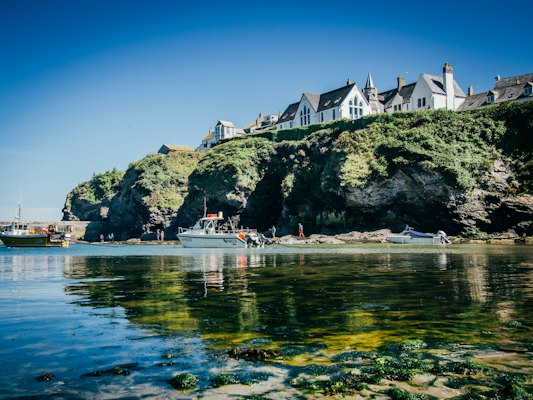White and gray concrete building near body of water during daytime — Cornwall, United Kingdom
