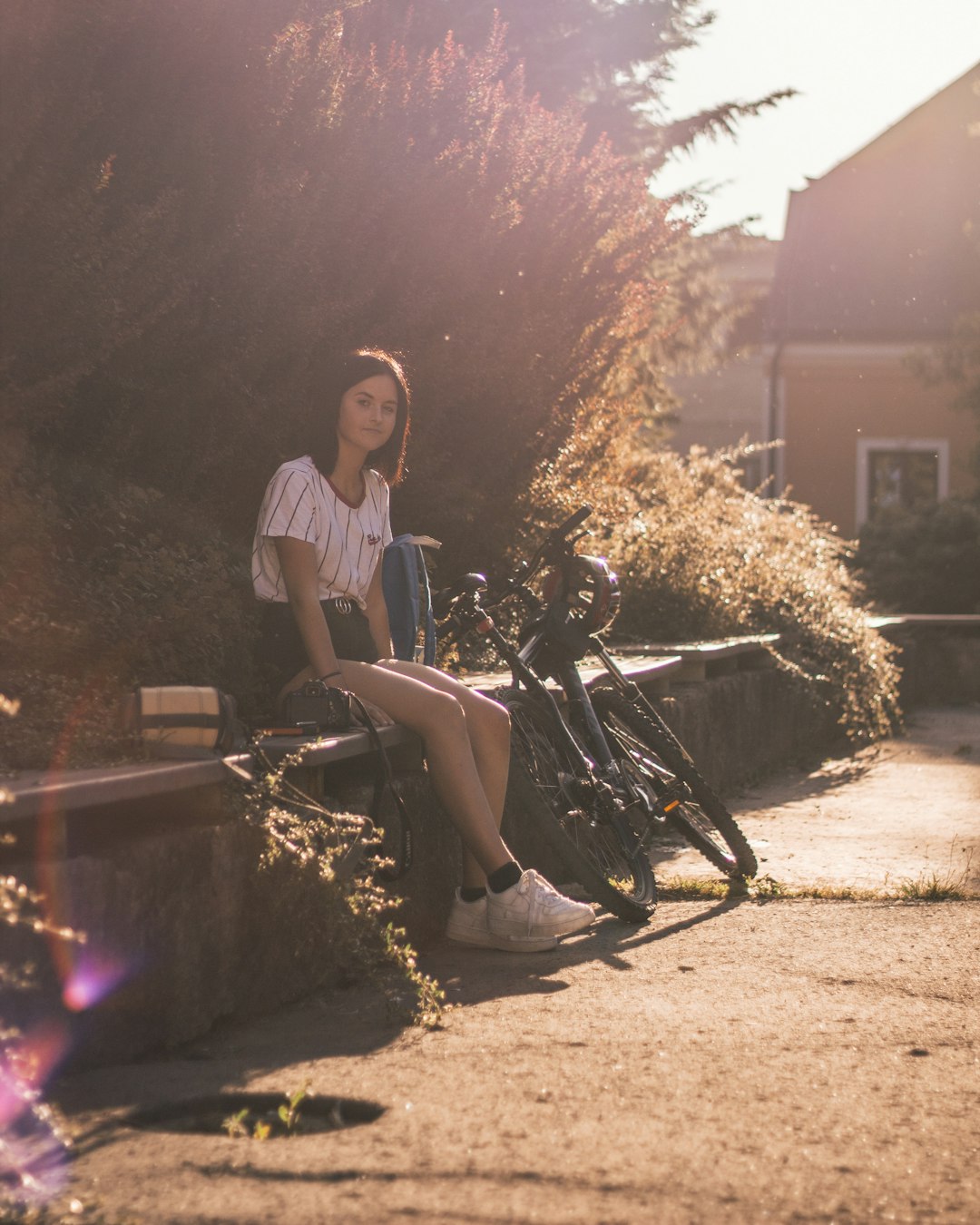 woman in white and black stripe shirt sitting on black bicycle during night time