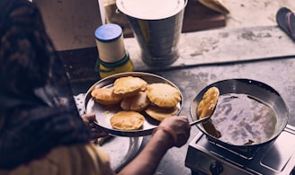 person cooking on black pan