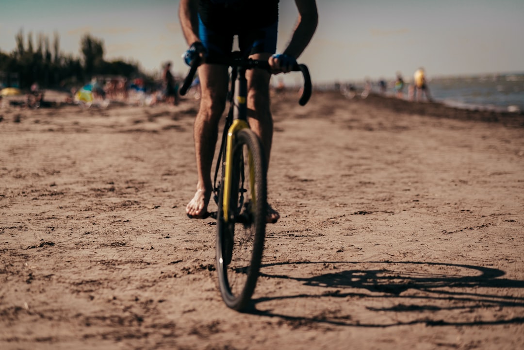 black bicycle on brown sand during daytime