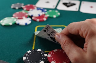 person holding white and black playing cards