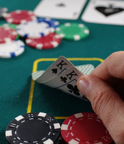 person holding white and black playing cards