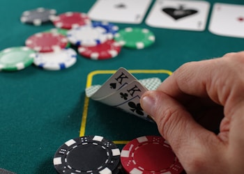 person holding white and black playing cards