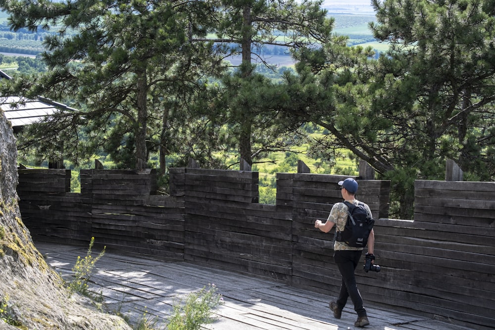 man in brown jacket walking on gray concrete pathway during daytime