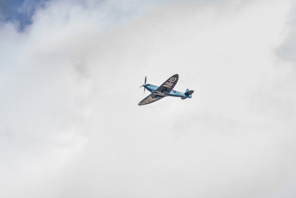 blue and white airplane flying in the sky