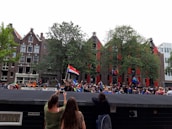 Students attending a lively university event outdoors with colorful banners.