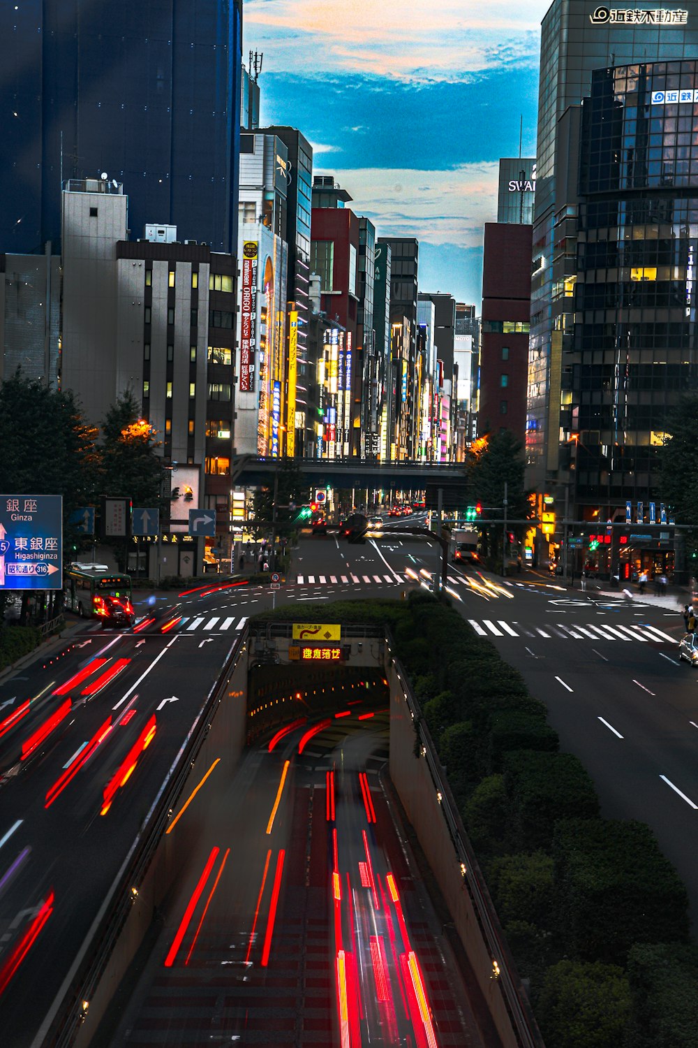 cars on road near high rise buildings during night time