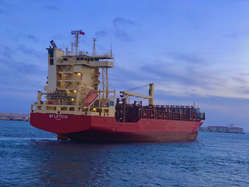 red and white ship on sea during daytime