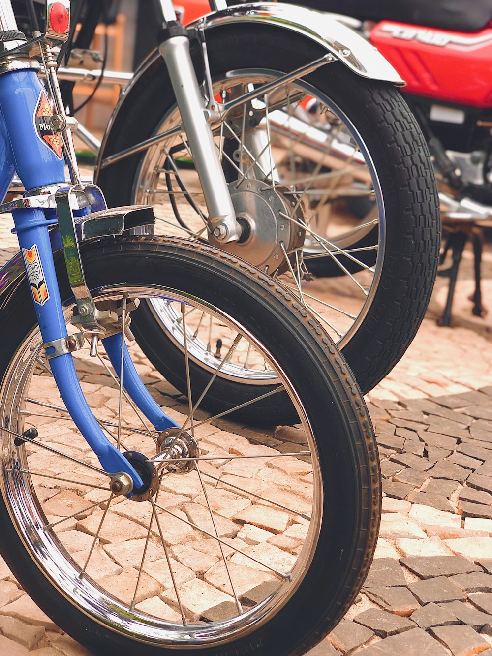 blue and black bicycle on brown brick floor