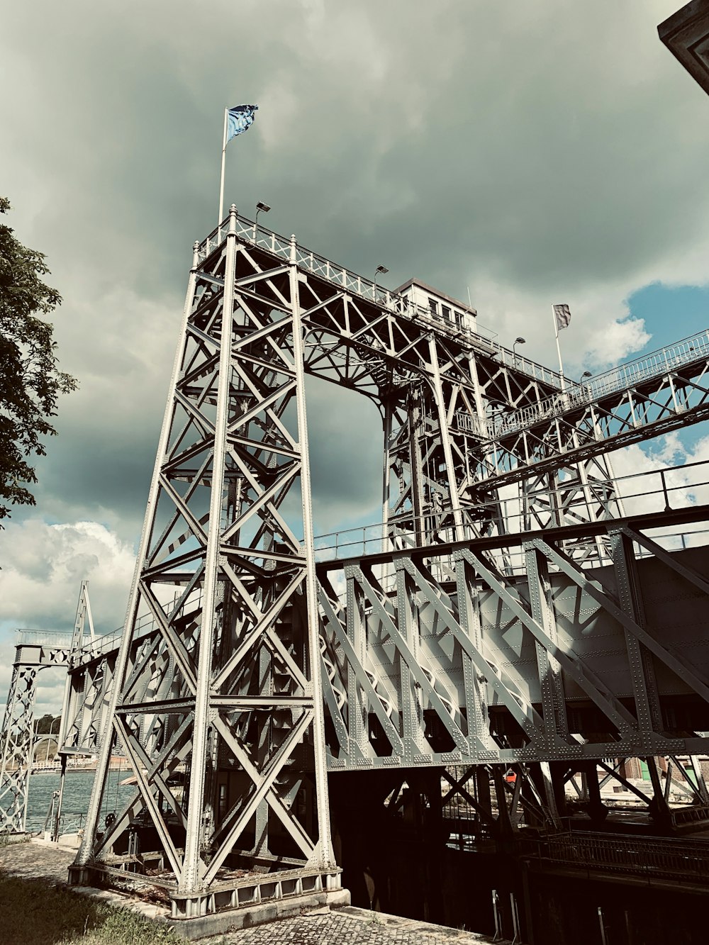 red metal bridge under white clouds during daytime